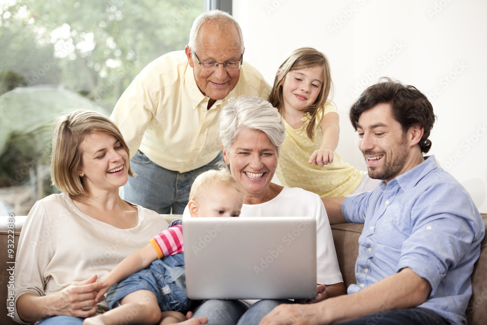 Extended family on couch using laptop Extended family on couch using laptop