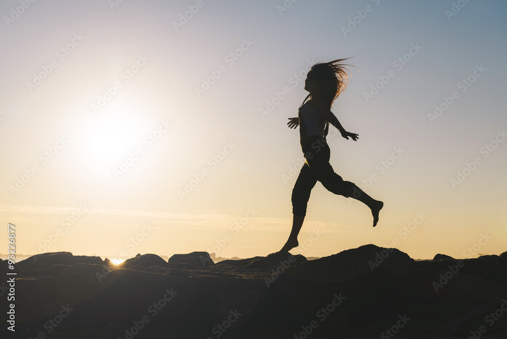 Silhouette of running woman at backlight Silhouette of running woman at backlight