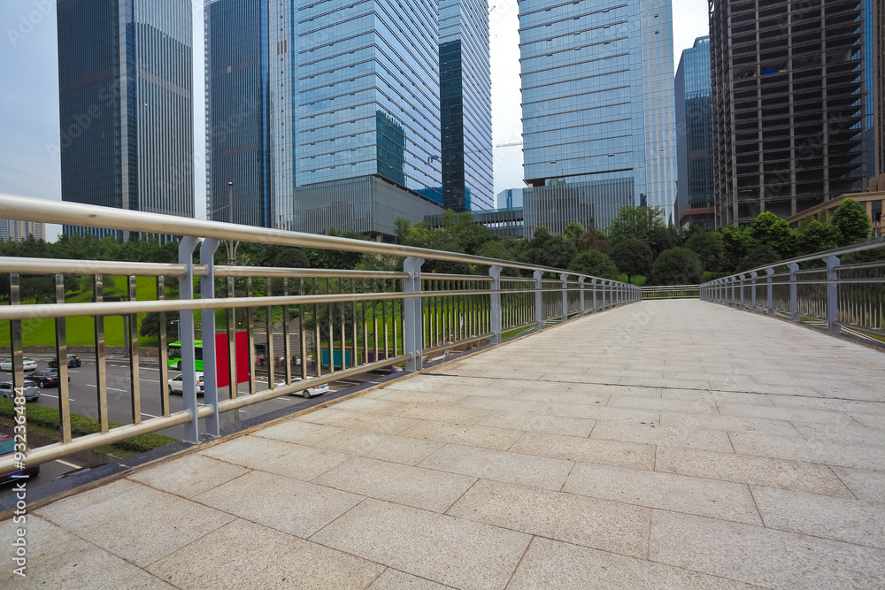 Empty road surface with modern city buildings background Empty road surface with modern city buildings background