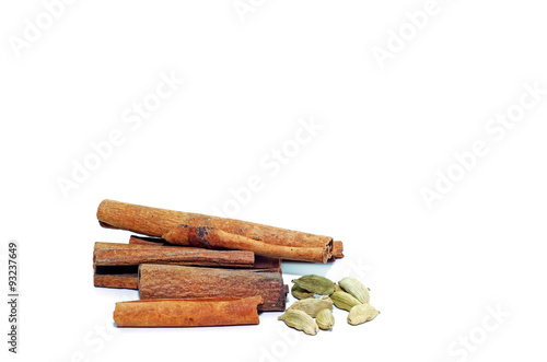 Cinnamon sticks and cardamom isolated on white background