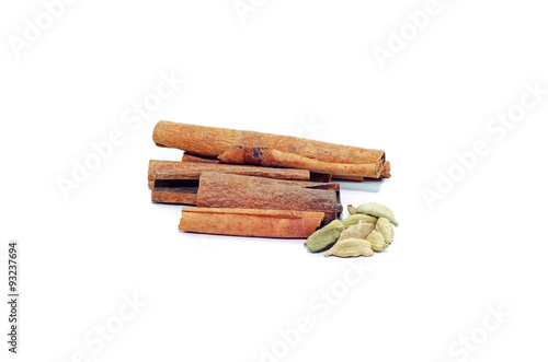 Cinnamon sticks and cardamom isolated on white background