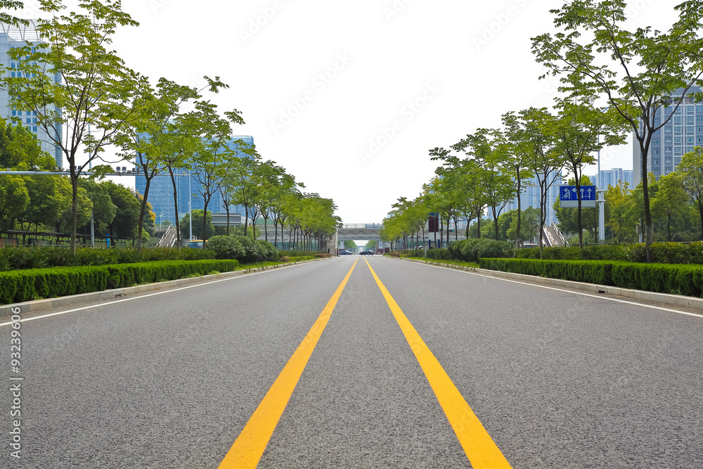 Empty road surface with modern city buildings background Empty road surface with modern city buildings background
