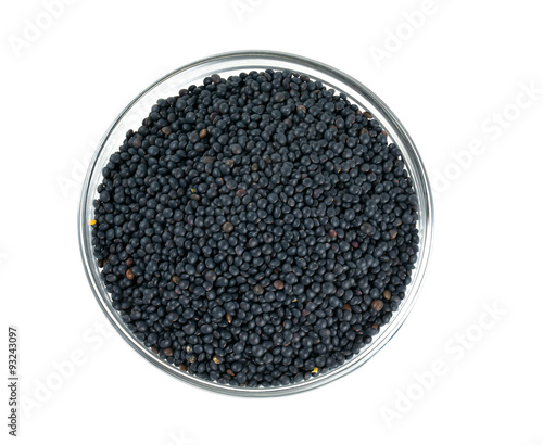 black lentils in a bowl isolated on white
