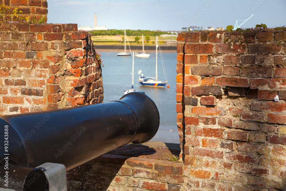 ROCHESTER, UK - MAY 16, 2015:  Old cannon of Upnor Castle looking to the river Kent. Upnor Castle is an Elizabethan artillery fort located on the west bank of the River Medway in Kent. 
