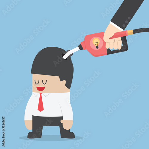 Businessman refuelling his idea by fuel nozzle
