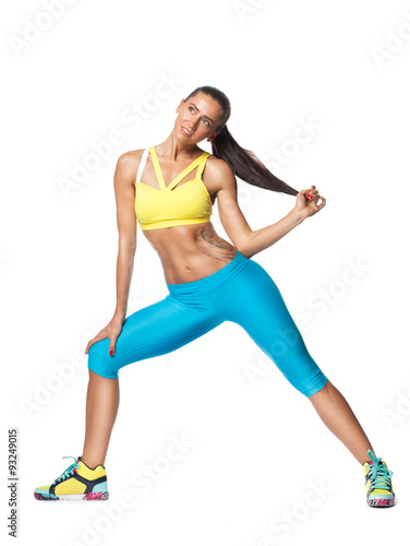 Smiling tanned sportswoman in sporty pose looking up