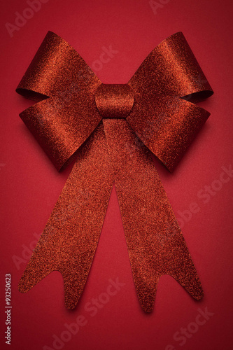 Red gift bow. Ribbon. On Red background