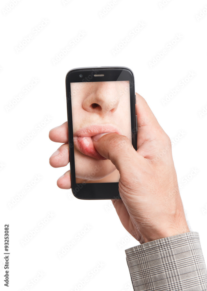 Hand holding mobile phone with lips sucking thumb