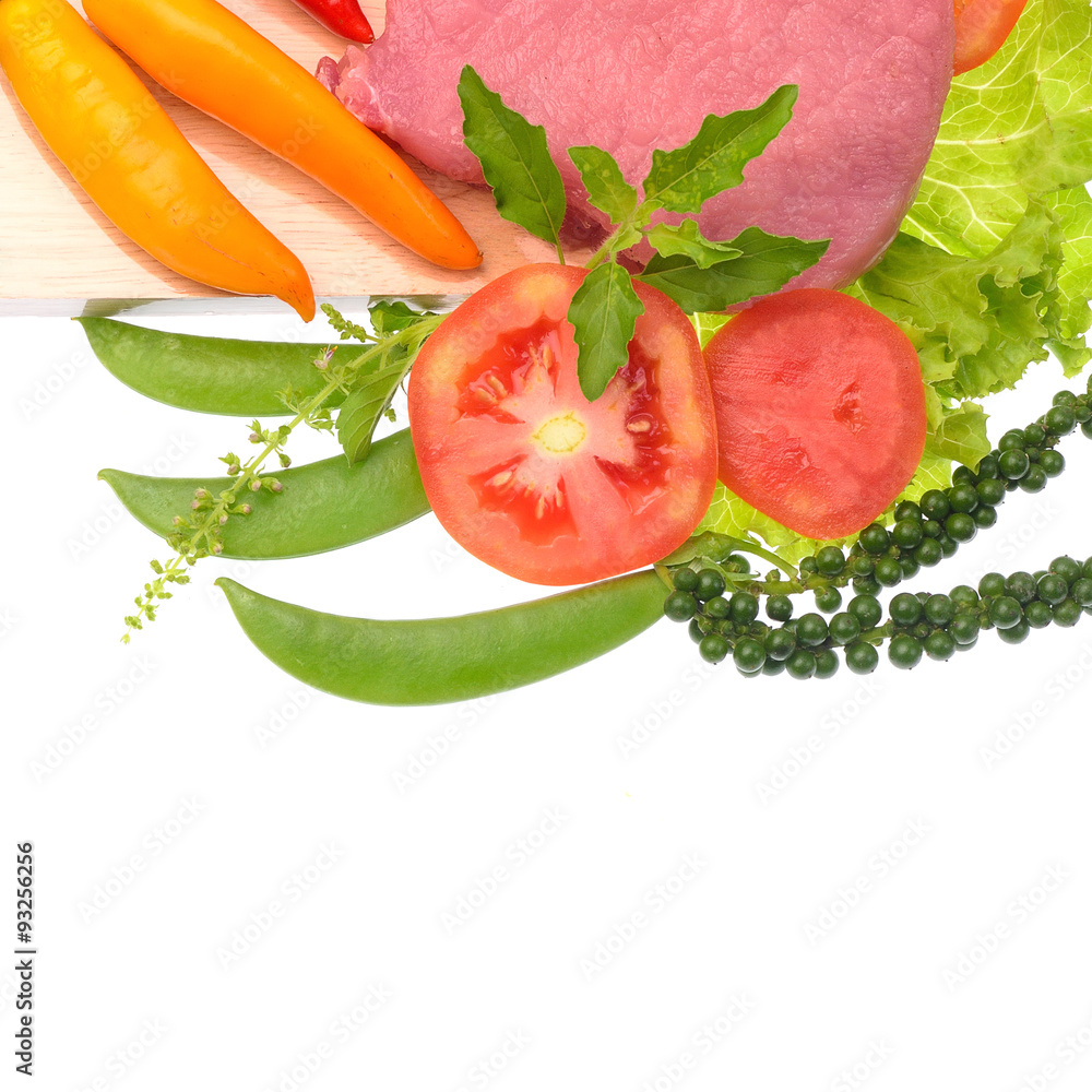 Raw pork meat isolated with vegetables and herbs Raw pork meat isolated with vegetables and herbs
