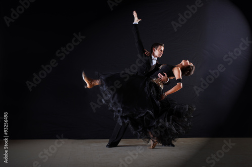 Dancers in ballroom at black background