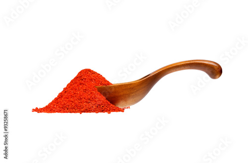 Powdered pimienta roja red pepper in the wooden spoon, isolated on white background. photo