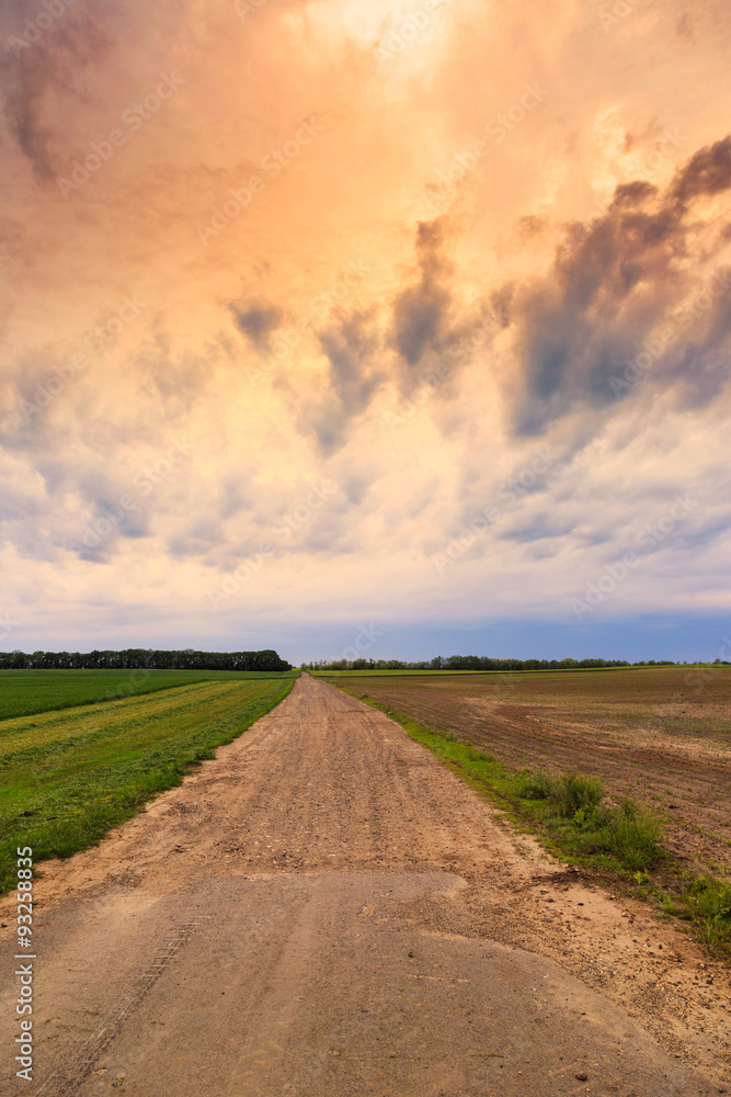 Dirty road to dramatic sky