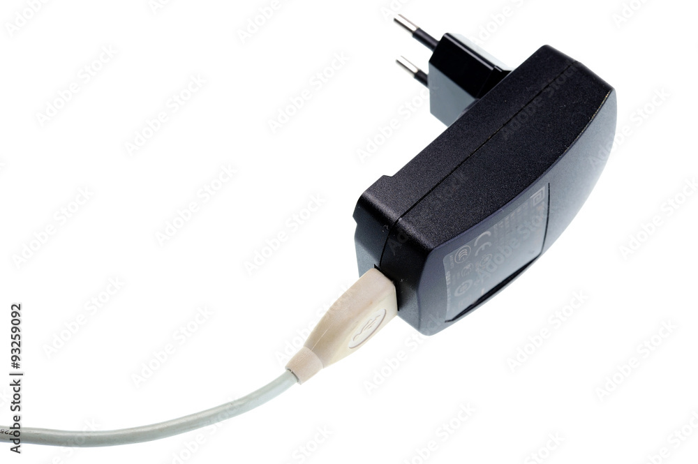 Black AC-DC power supply adapter with USB connector. Black AC-DC power supply adapter with USB connector.