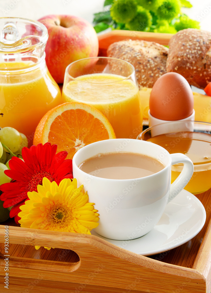Breakfast on tray served with coffee, juice, egg, and rolls Breakfast on tray served with coffee, juice, egg, and rolls