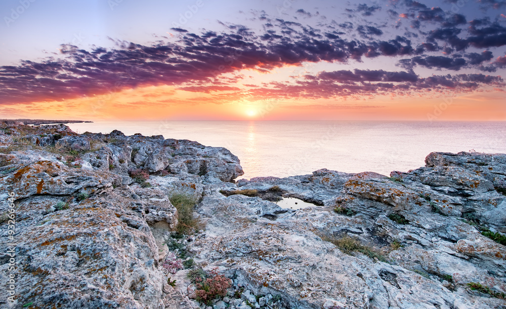 Colorful sunrise on the rocky coast.