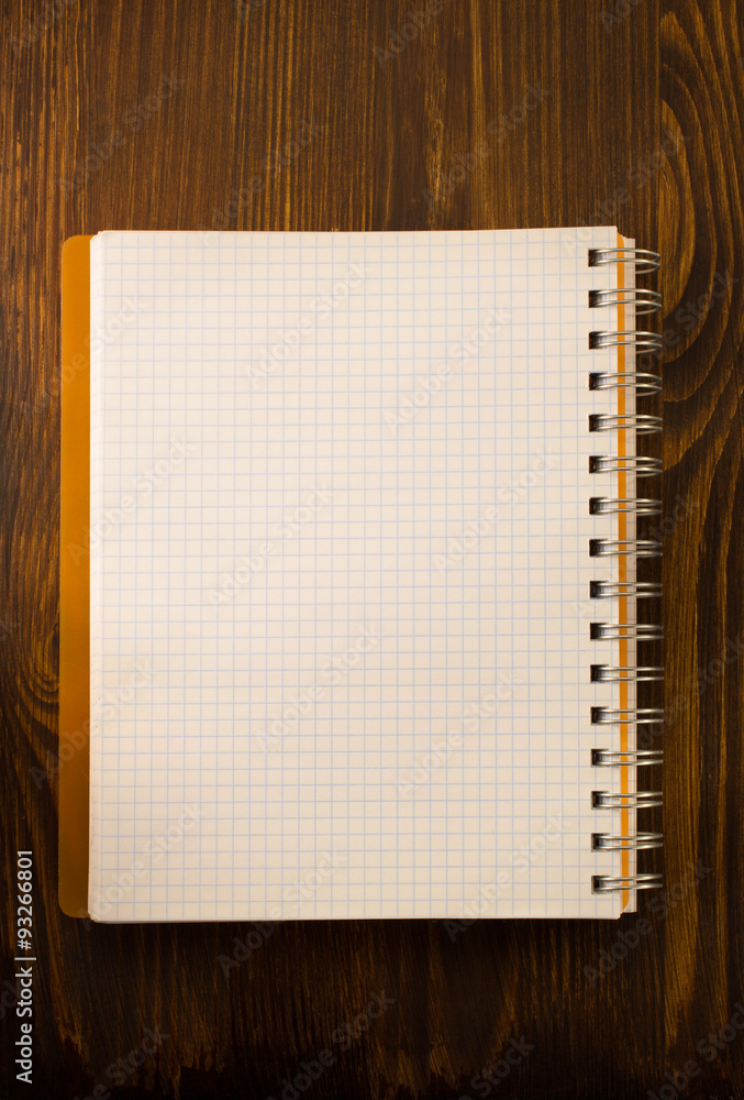 checked notebook on wood checked notebook on wood