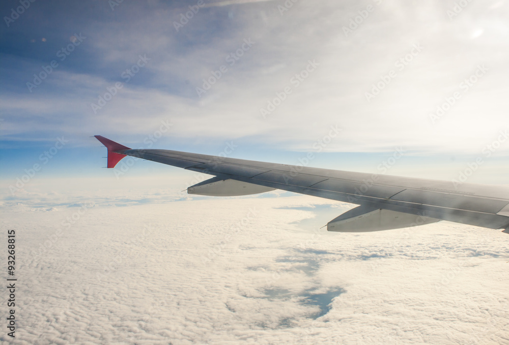 Fototapeta premium wing airplane high above the clouds