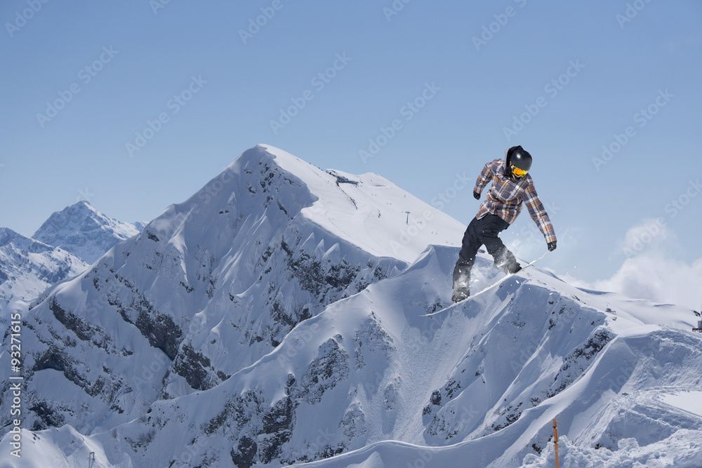 Flying snowboarder on mountains Flying snowboarder on mountains