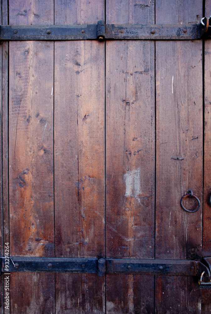 Old wooden dark brown door with metal details Old wooden dark brown door with metal details