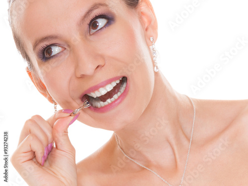 Bride woman biting engagement ring.