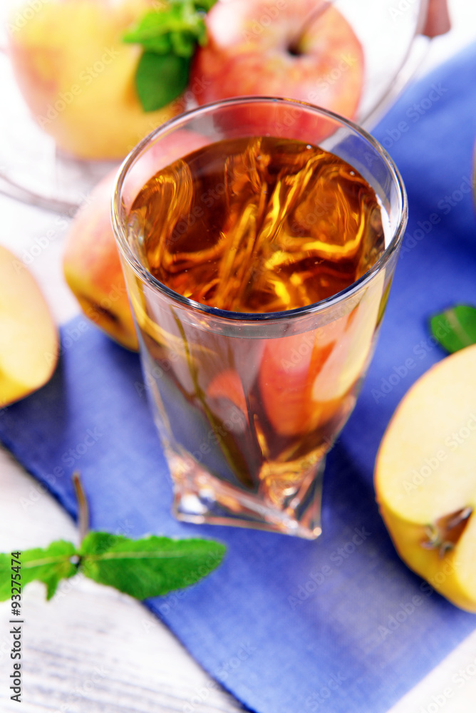 Glass of apple juice with fruits and fresh mint on table close up Glass of apple juice with fruits and fresh mint on table close up
