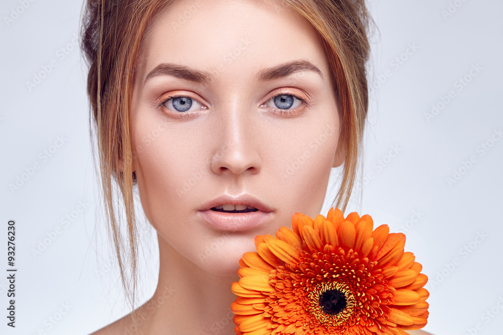 Close-up face of girl with flower in her hand Close-up face of girl with flower in her hand