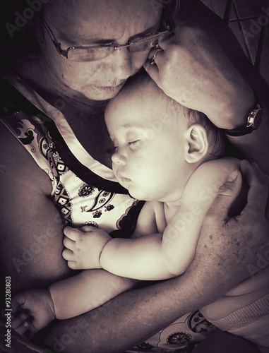 Grandmother relaxing with her granddaughter on sepia photo