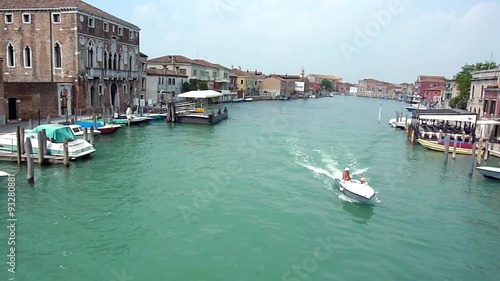 Boat sailing in the canal in the island of Murano photo