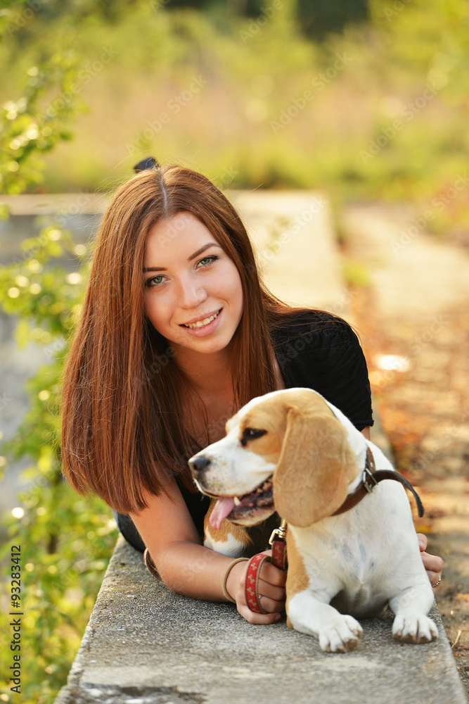 beautiful woman and his dog posing outside
