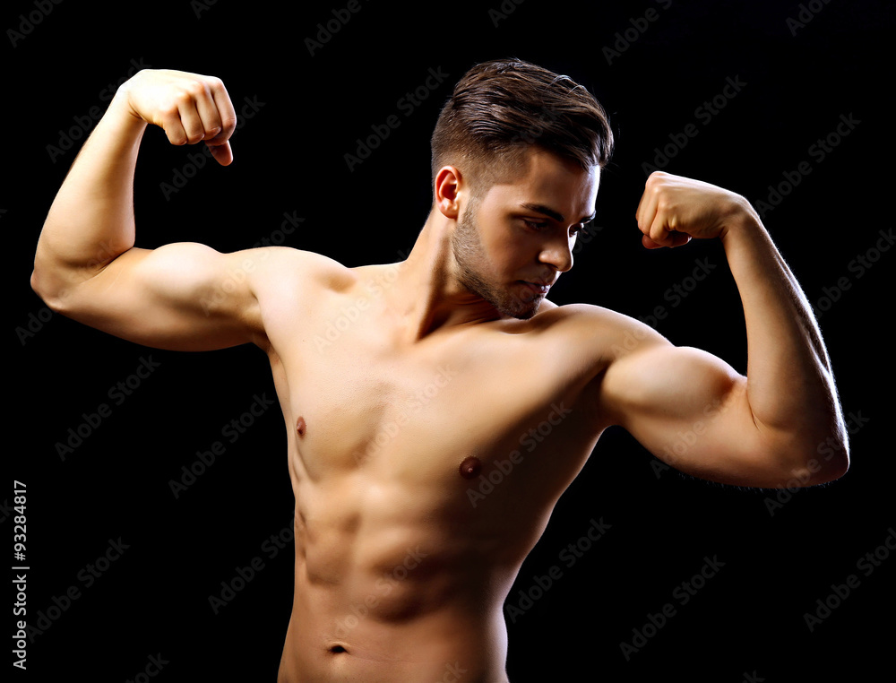 Muscle young man on dark background Muscle young man on dark background