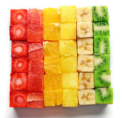 Colorful fresh sliced fruit cubes isolated on white