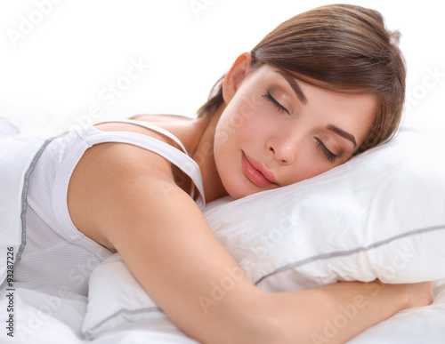 Beautiful girl sleeps in the bedroom, lying on bed