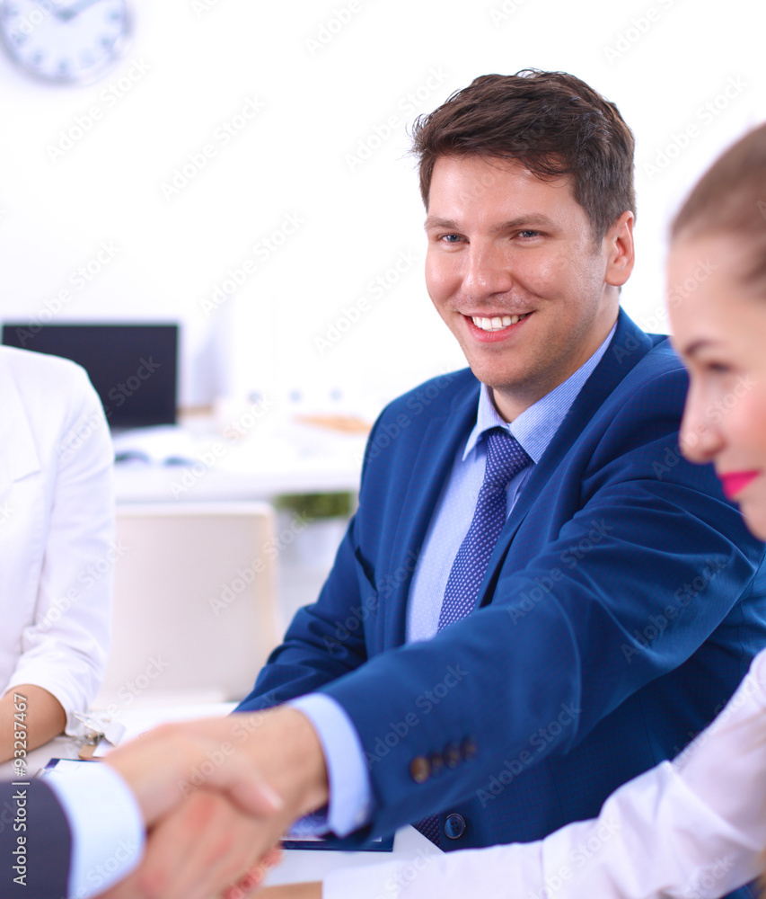 Business people shaking hands, finishing up a meeting, in office Business people shaking hands, finishing up a meeting, in office