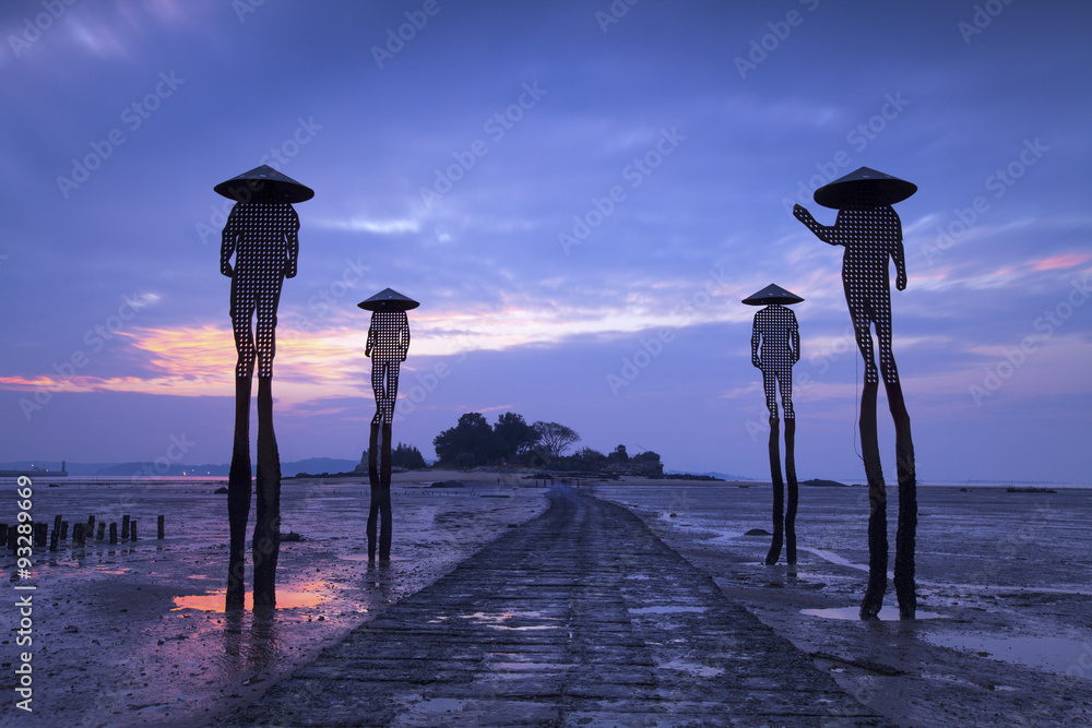 Four fishermen sculptures at low tide in kinmen, Taiwan