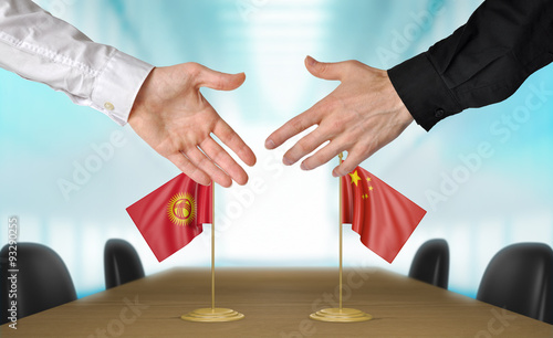 Kyrgyzstan and China diplomats agreeing on a deal