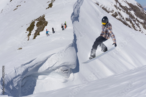 Flying snowboarder on mountains