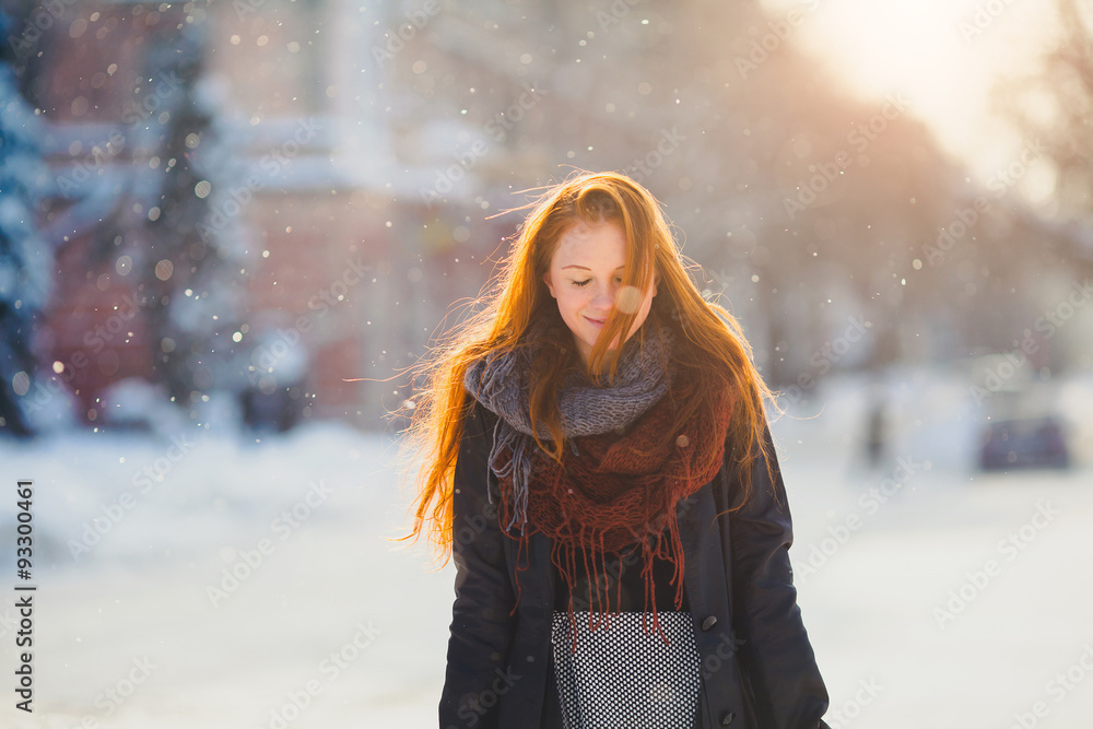 Positive redhead girl on the sun in frozen winter day Positive redhead girl on the sun in frozen winter day