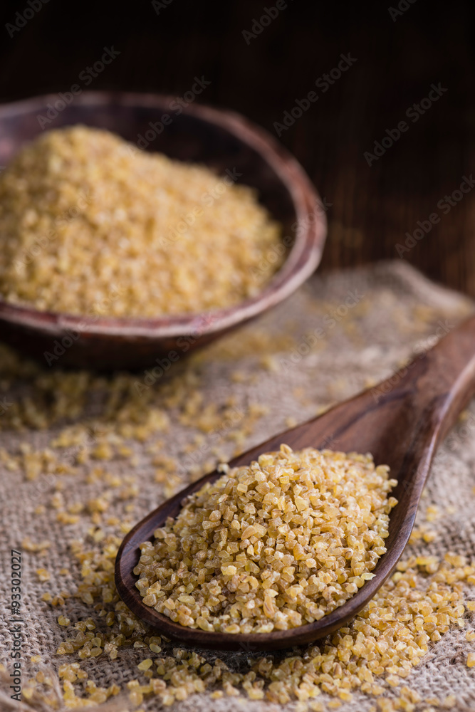Raw Bulgur (on wooden background) Raw Bulgur (on wooden background)