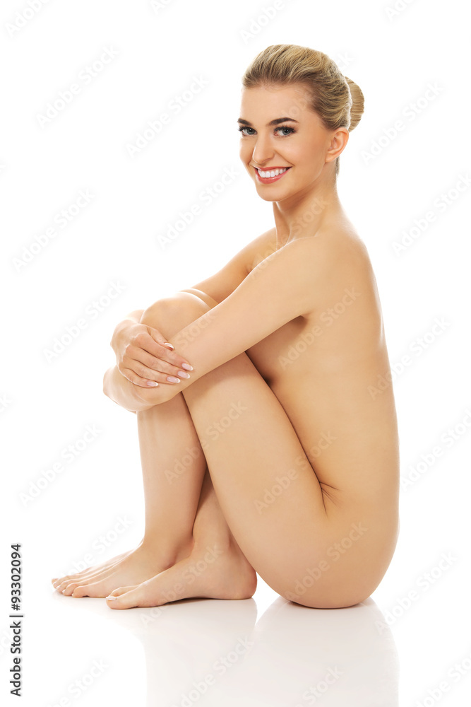 Fototapeta premium Young naked woman sitting on the floor