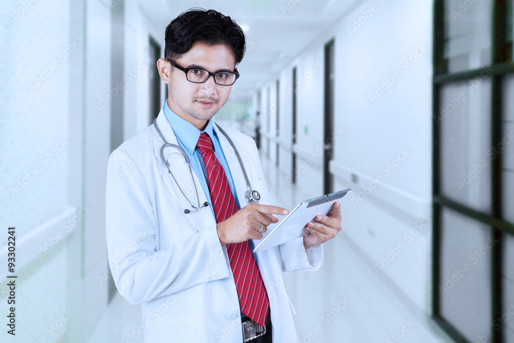 Male doctor using tablet in the hospital