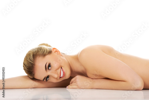 Beautiful naked woman lying on the floor.