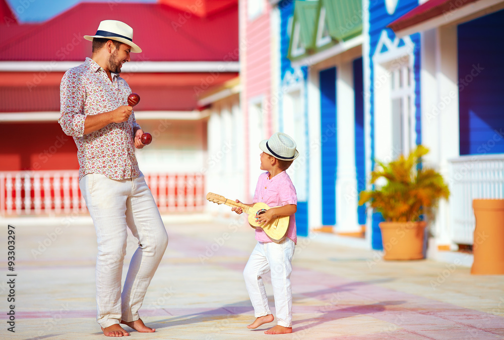 Fototapeta premium happy family playing music and dancing on caribbean street