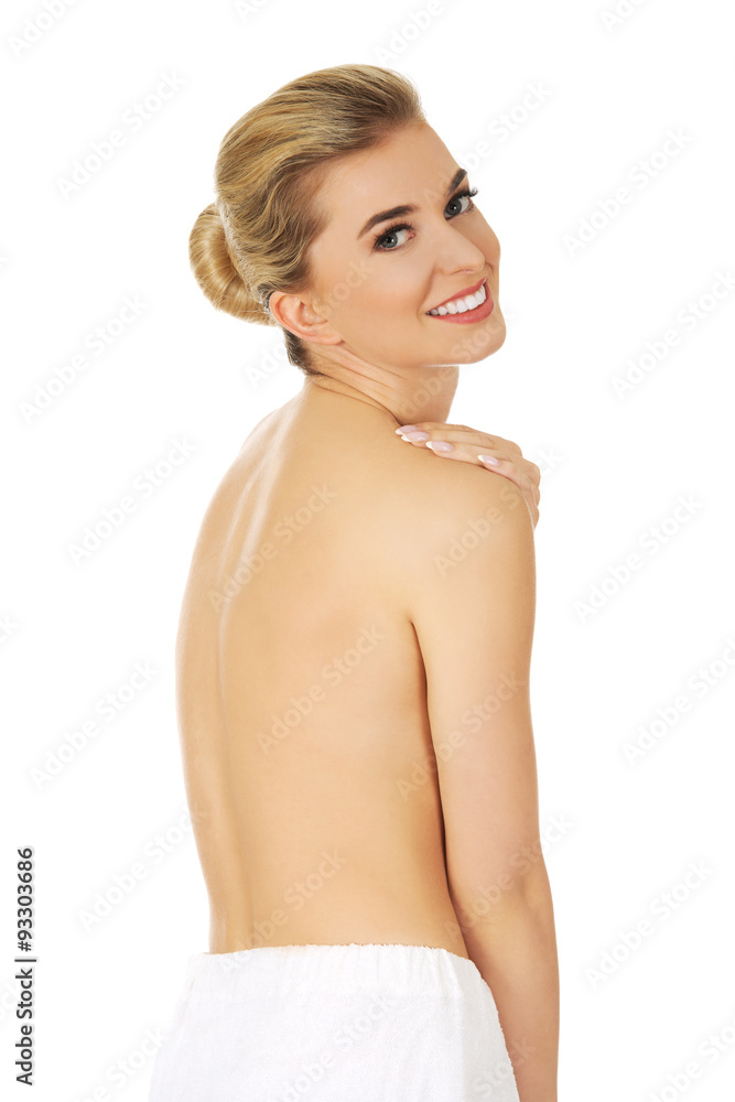 Obraz premium Young smile topless woman with white towel around her waist.