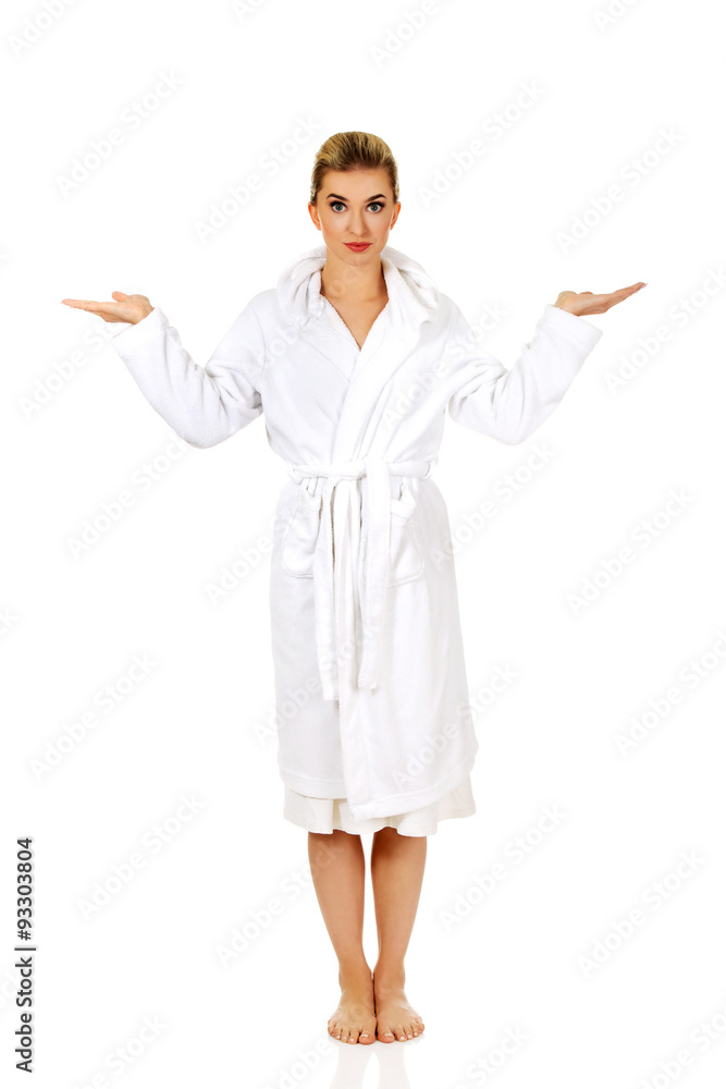 Young surprised woman after bath holding something Young surprised woman after bath holding something