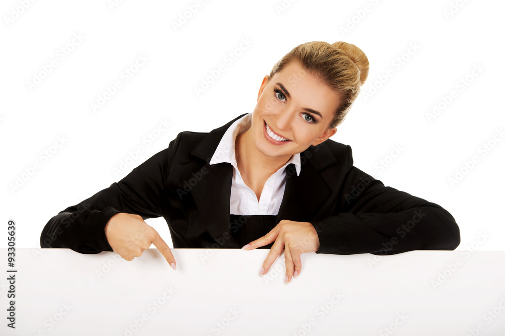 Happy businesswoman pointing on empty banner. Happy businesswoman pointing on empty banner.