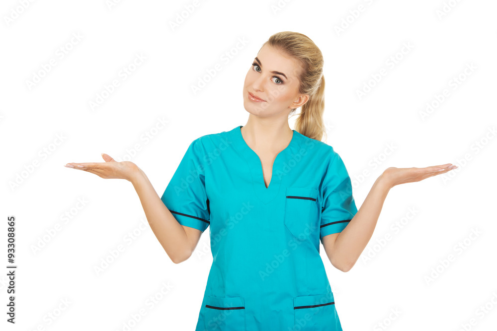 Smiling woman doctor or nurse pointing something