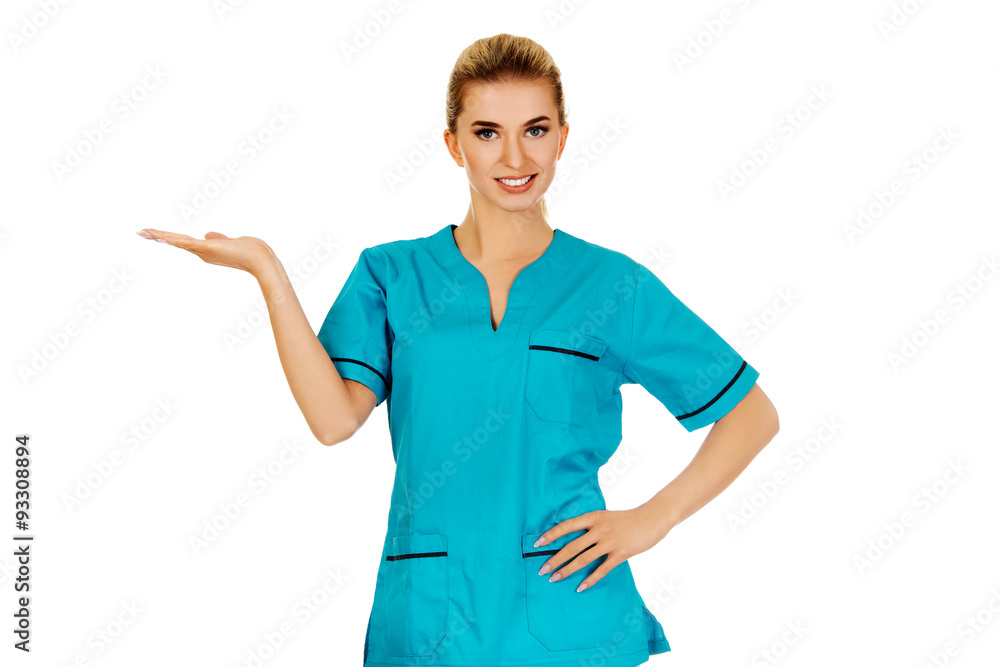 Smiling woman doctor or nurse pointing something Smiling woman doctor or nurse pointing something