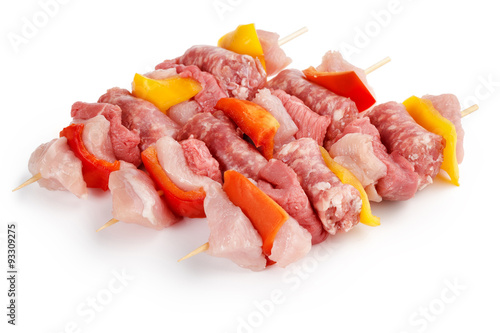 three raw meat skewers isolated on white background