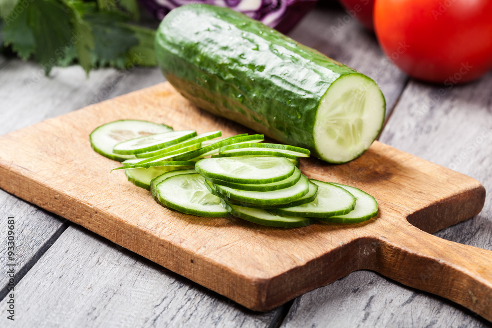Chopped vegetables: cucumber on cutting board Chopped vegetables: cucumber on cutting board