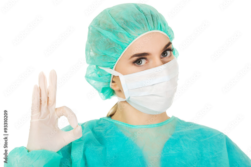 Young woman surgeon doctor shows perfect sign Young woman surgeon doctor shows perfect sign